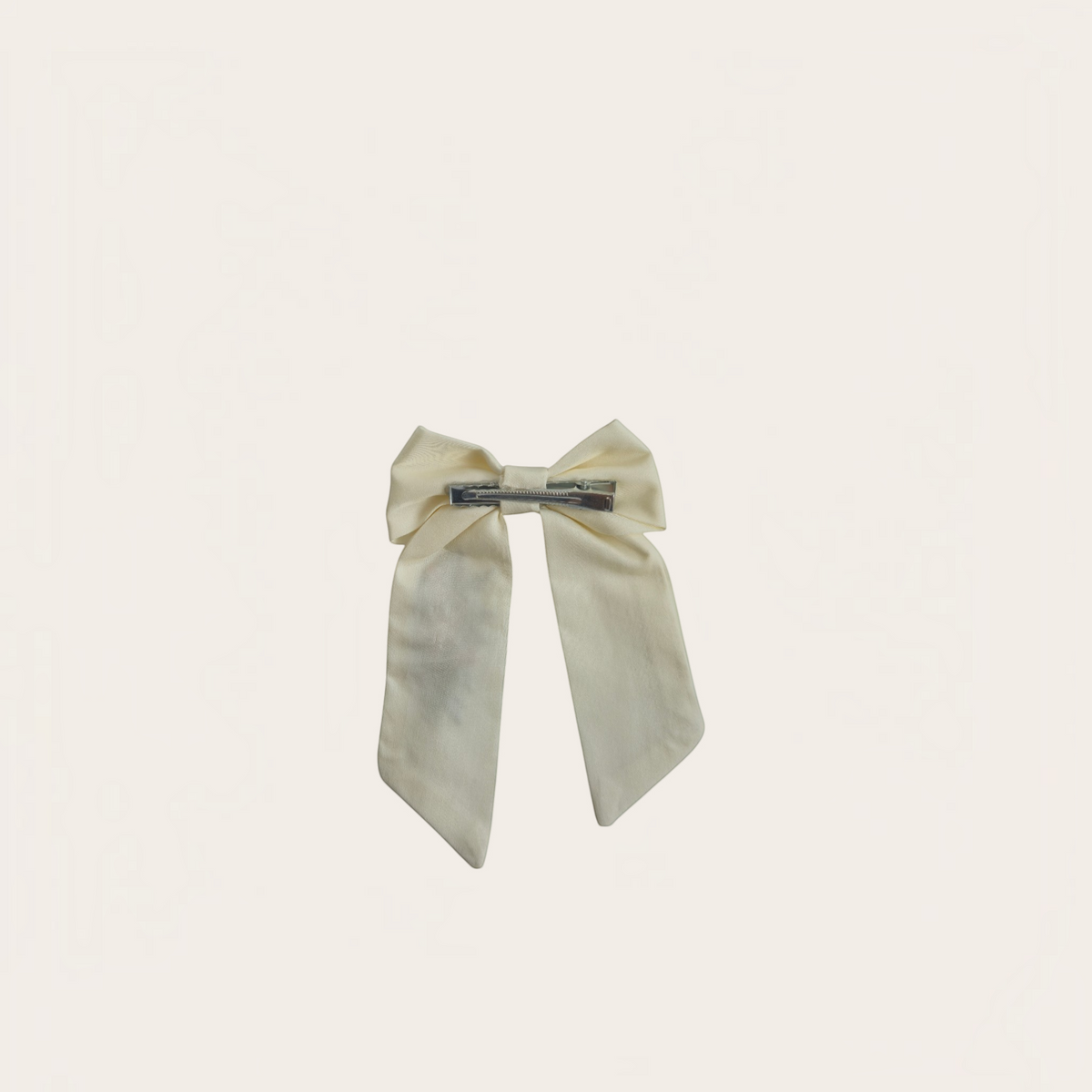 Grace Upon Grace ivory sailor bow hair clip with long tails, shown from the back featuring a secure metal clip