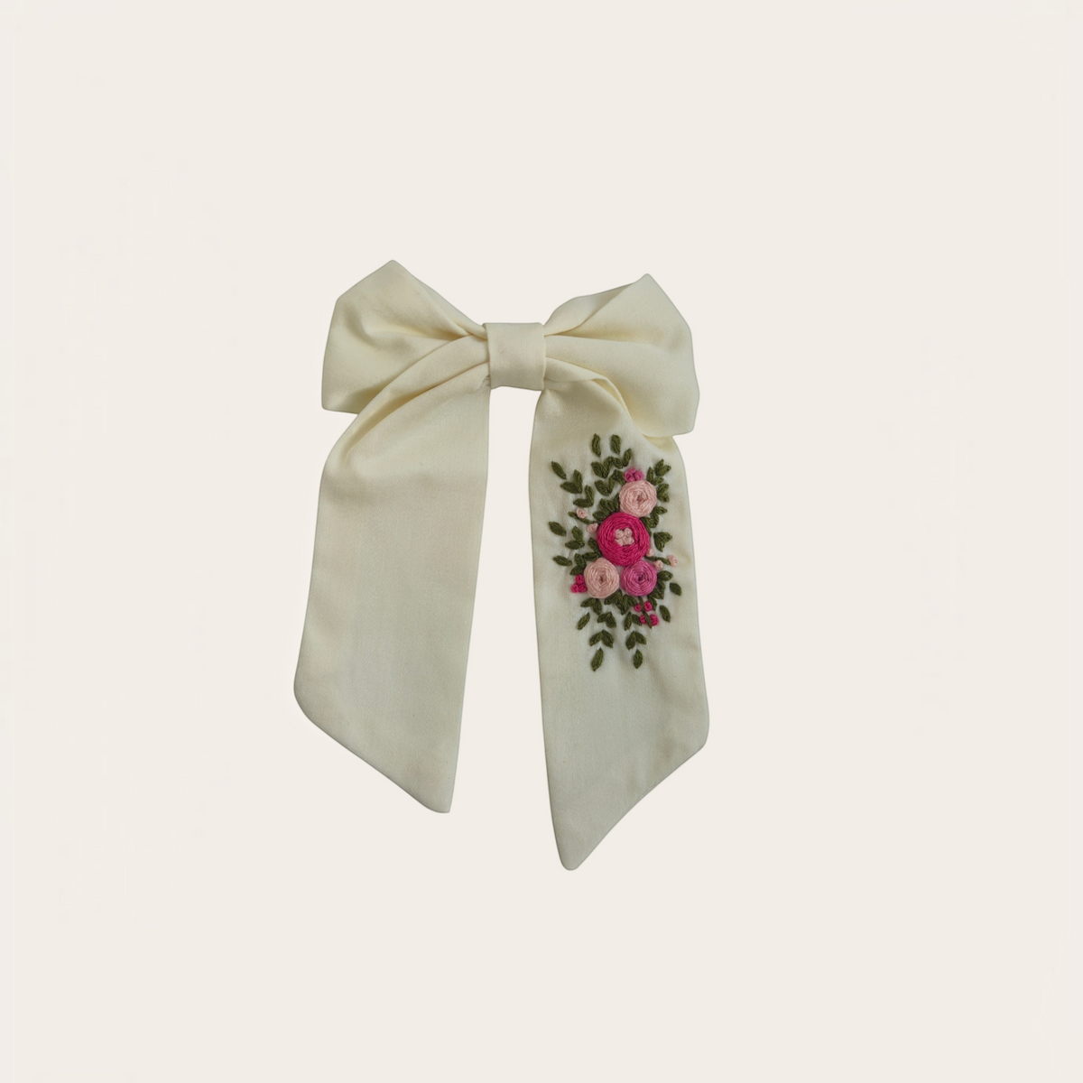 Grace Upon Grace ivory sailor bow featuring hand-embroidered pink bullion roses and green leaves on a hair clip