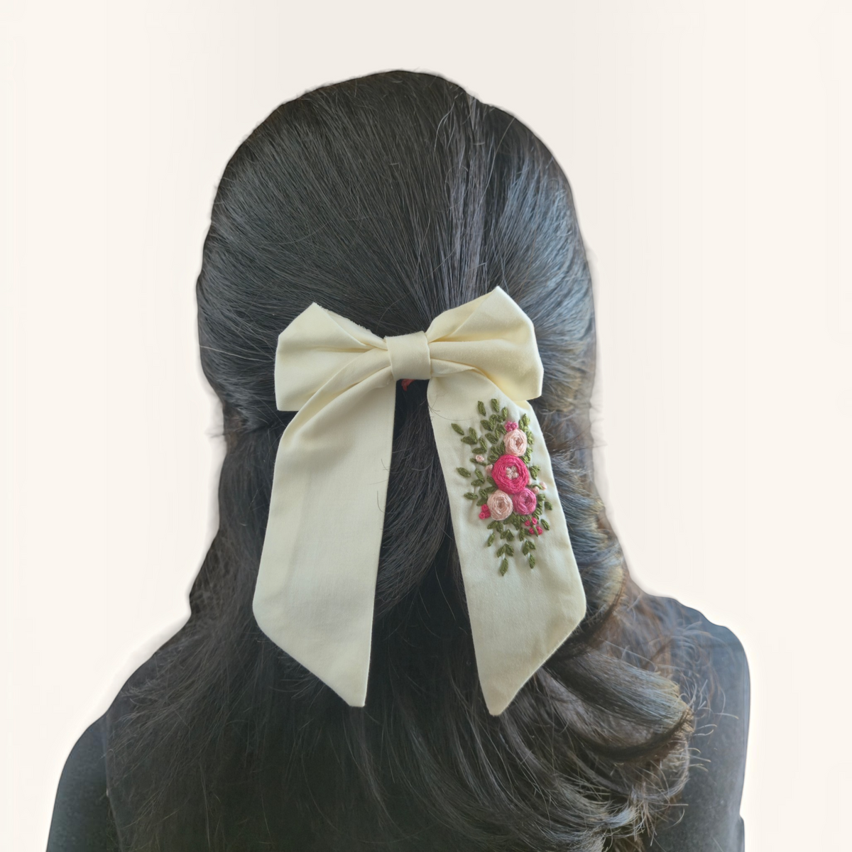 Grace Upon Grace ivory sailor bow with hand-embroidered pink roses and green leaves worn in dark hair