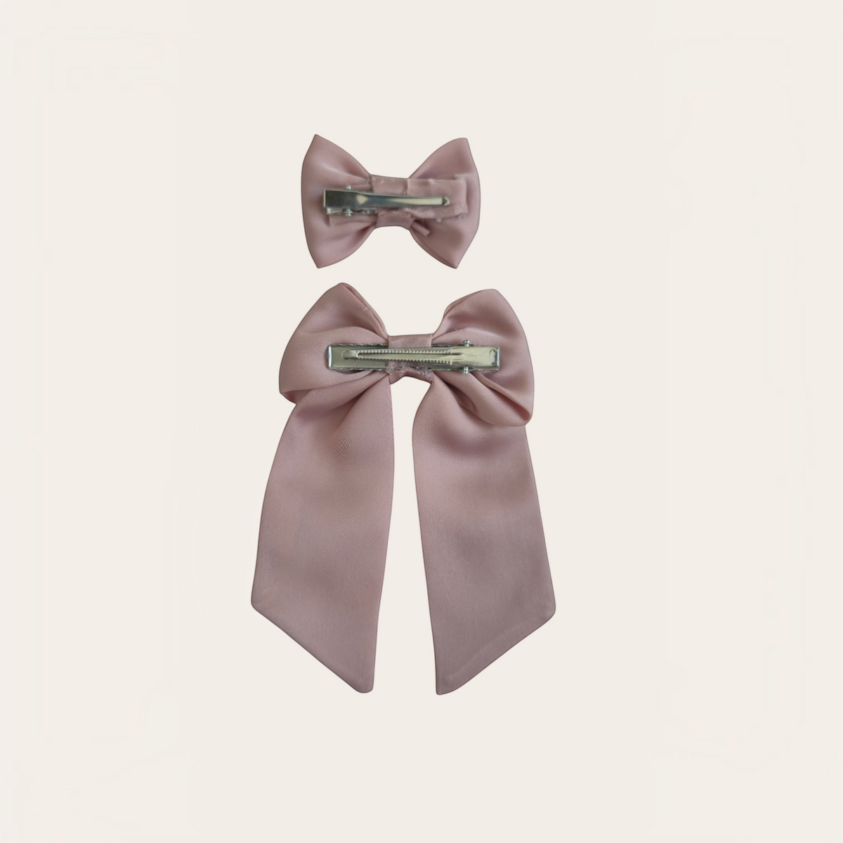Grace Upon Grace dusty rose satin hair bow duo featuring one small bow and one long-tailed sailor bow on metal clips.