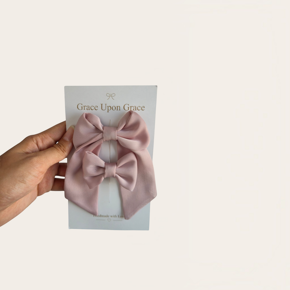 Grace Upon Grace dusty rose satin hair bow duo featuring a long sailor bow and a small mini bow on clips.